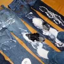 Diesel jeans stomped with paint covered sneakers